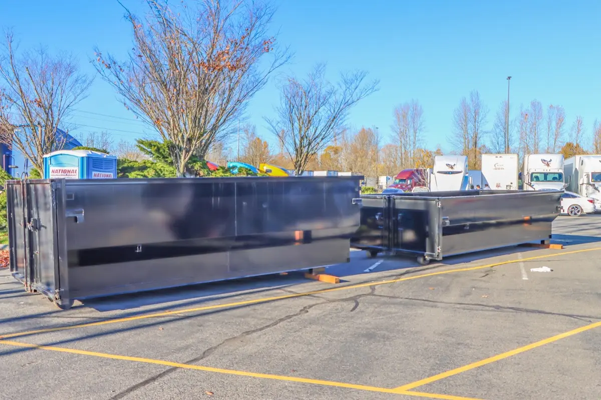 Professional dumpster rental service with roll-off container on residential driveway in Pawling